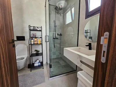 a bathroom with a shower and a sink and a toilet at Central Luxurious & Great Location Ultra Fast Wi-Fi In The Heart Of Casablanca Oasis Disrict With A City View in Casablanca