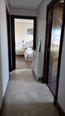a room with a bedroom with a bed and a mirror at Bel appartement in Mohammedia