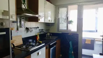 a kitchen with a sink and a stove top oven at Bel appartement in Mohammedia