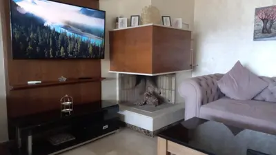 a living room with a couch and a fireplace at Bel appartement in Mohammedia