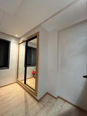 a room with a mirror on a white wall at Zahira New Luxury Near The Beach - Entire Apartment in Casablanca