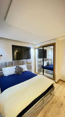 a bedroom with a large bed and a large mirror at Zahira New Luxury Near The Beach - Entire Apartment in Casablanca
