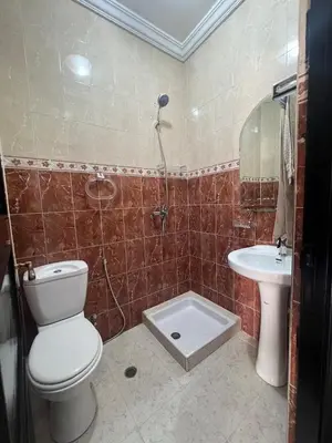 a bathroom with a toilet and a sink at Longement moderne à Rabat in Rabat