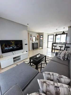 a living room with a couch and a flat screen tv at chic escape in Casablanca