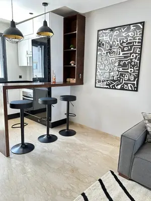 a living room with a desk and stools at chic escape in Casablanca