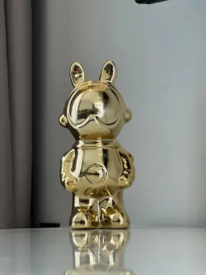 a gold figurine of a teddy bear on a table at chic escape in Casablanca
