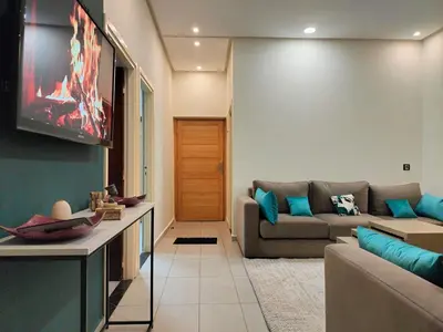 a living room with a couch and a tv at Charming apartment agdal rabat in Rabat