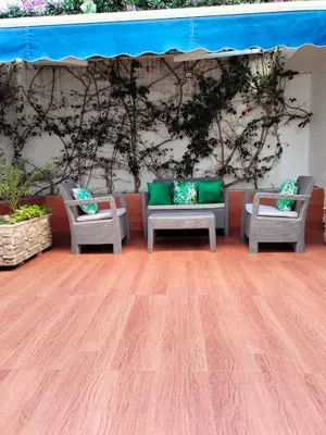 a room with two chairs and a wall with plants at Charming apartment agdal rabat in Rabat