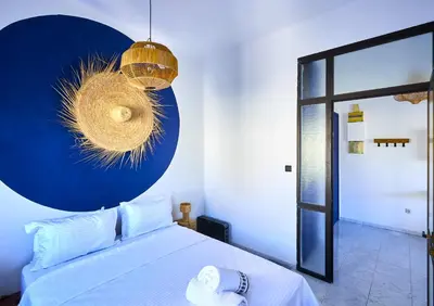 a bedroom with a bed and a blue wall at Suite BD ANFA - Queen Bed & Private Balcony in Casablanca
