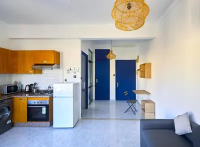 a kitchen and living room with a white refrigerator at Suite BD ANFA - Queen Bed & Private Balcony in Casablanca