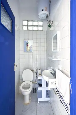 a white bathroom with a toilet and a sink at Suite BD ANFA - Queen Bed & Private Balcony in Casablanca