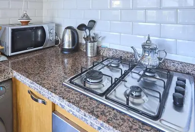 a kitchen counter with a stove and a microwave at Suite BD ANFA - Queen Bed & Private Balcony in Casablanca