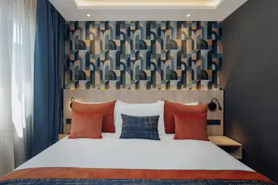 a bedroom with a large bed with red and blue pillows at Exe Casablanca in Casablanca