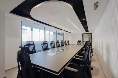 a conference room with a long table and black chairs at Exe Casablanca in Casablanca