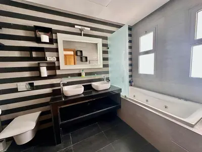 a bathroom with black and white stripes on the wall at 360 Sea View - Marina - Spacious 3 BR Retreat in Casablanca