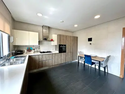 a kitchen with a table and blue chairs in it at 360 Sea View - Marina - Spacious 3 BR Retreat in Casablanca