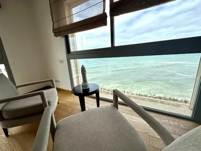 a living room with chairs and a large window with the ocean at 360 Sea View - Marina - Spacious 3 BR Retreat in Casablanca