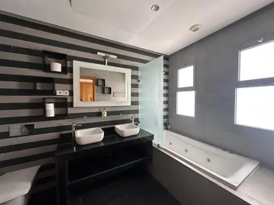 a bathroom with two sinks and a bath tub and a mirror at 360 Sea View - Marina - Spacious 3 BR Retreat in Casablanca