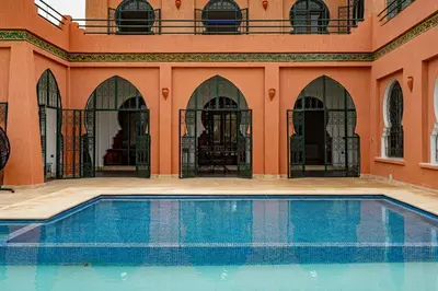 a swimming pool in front of a building at Domaine Terra Cotta - Villa de luxe avec piscine sans vis-à-vis in Souk el Had