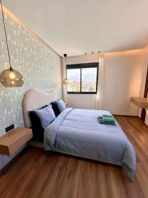 a bedroom with a large bed and a window at Ain Diab Ocean Breeze & Parking in Casablanca