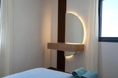 a bedroom with a bed and a mirror on the wall at Ain Diab Ocean Breeze & Parking in Casablanca