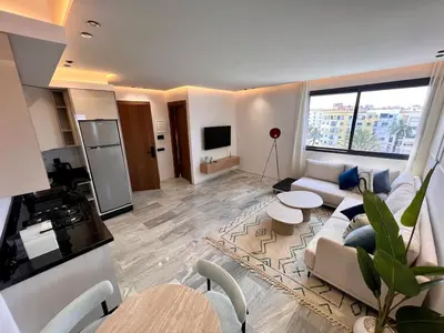 a living room with a couch and a table at Ain Diab Ocean Breeze & Parking in Casablanca