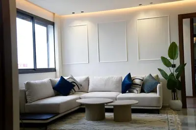 a living room with a couch and a table at Ain Diab Ocean Breeze & Parking in Casablanca