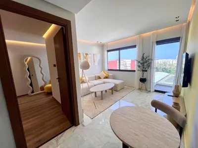 a living room with a door open to a living room at Ain Diab Sunrise Nest & Parking in Casablanca