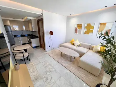 a living room with a couch and a table at Ain Diab Sunrise Nest & Parking in Casablanca