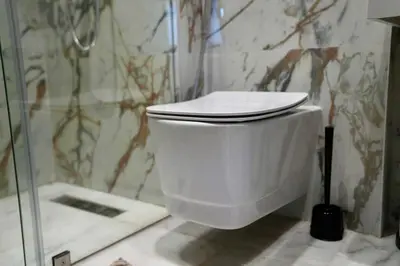 a white toilet in a bathroom with a shower at Ain Diab Sunrise Nest & Parking in Casablanca