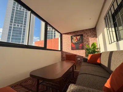 a living room with a couch and a table at Stylish loft with view and terrace Maarif Gauthier in Casablanca