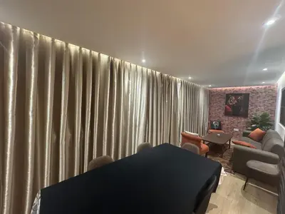 a living room with curtains and a table and chairs at Stylish loft with view and terrace Maarif Gauthier in Casablanca