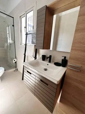 a bathroom with a white sink and a shower at Stylish loft with view and terrace Maarif Gauthier in Casablanca