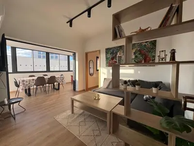 a living room with a couch and a table at Stylish loft with view and terrace Maarif Gauthier in Casablanca