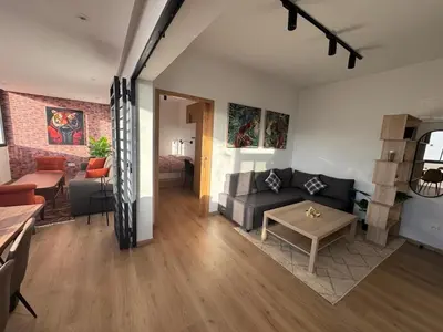 a living room with a couch and a table at Stylish loft with view and terrace Maarif Gauthier in Casablanca