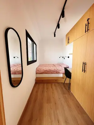 a bedroom with a bed and a mirror on the wall at Stylish loft with view and terrace Maarif Gauthier in Casablanca
