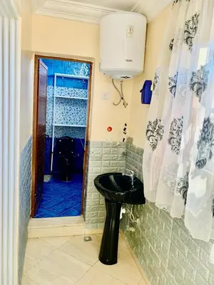 a bathroom with a sink and a cat in the doorway at familly house in Tamaris