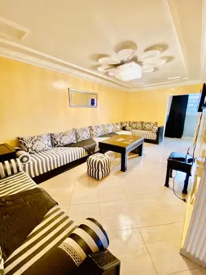 a living room with couches and a table at familly house in Tamaris