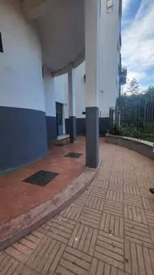 a large building with columns and a brick floor at Cozy home in a good location in Mohammedia