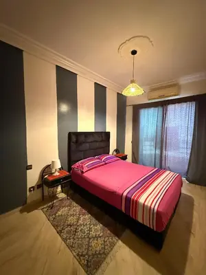 a bedroom with a large bed with a pink blanket at Casablanca studio in Casablanca
