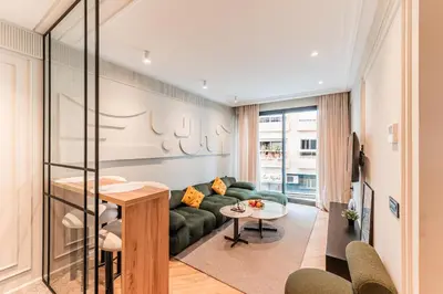 a living room with a green couch and a table at Le Claridge - Cosy Studio - By Mi-Haven in Casablanca