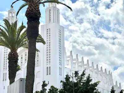a white building with palm trees in front of it at Le Claridge - Cosy Studio - By Mi-Haven in Casablanca