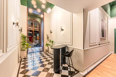 a hallway with a table and a checkered floor at Le Claridge - Cosy Studio - By Mi-Haven in Casablanca