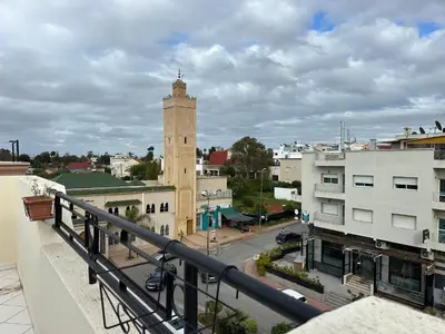 a view of a city with a clock tower at Wifaq temara in Temara