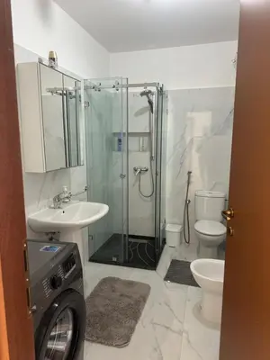 a bathroom with a shower and a sink and a toilet at Wifaq temara in Temara