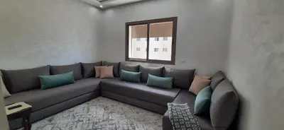 a living room with a couch and a window at Appartement lumineux près de la plage de Sidi Bouzid in El Jadida