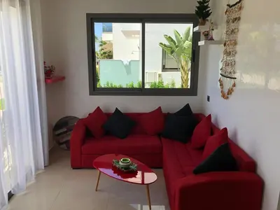 a living room with a red couch and a window at Villa Blanca - by Nero in Sidi Rahal