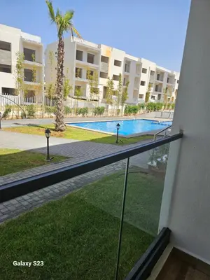 a view of a swimming pool from a balcony of a apartment at Appartement Harhoura La vallée pas loin de Arzana hotel in Temara