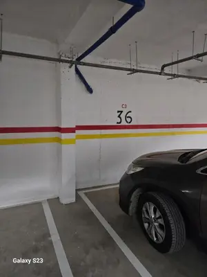 a parking garage with a car parked in it at Appartement Harhoura La vallée pas loin de Arzana hotel in Temara