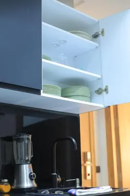 a kitchen with a counter top with plates on shelves at Charmant studio au cœur de Maarif - Confort balcon et emplacement idéal in Casablanca